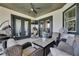 Cozy covered patio featuring a ceiling fan, comfortable seating, and stylish decor at 729 89Th N Ave, St Petersburg, FL 33702