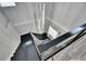 Modern staircase featuring sleek lines, a contemporary chandelier, and a view of the landing at 729 89Th N Ave, St Petersburg, FL 33702