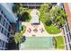 Overhead view of the community's shuffleboard courts, seating areas, and mature trees at 801 83Rd N Ave # 412, St Petersburg, FL 33702