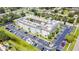 An aerial view of a well-maintained condo community with ample parking and lush landscaping at 801 83Rd N Ave # 412, St Petersburg, FL 33702
