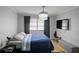 This bedroom offers a bright, neutral space with a modern chandelier and window at 801 83Rd N Ave # 412, St Petersburg, FL 33702