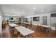 Large community room with wood flooring, tables, chairs and large windows, great for hosting events at 801 83Rd N Ave # 412, St Petersburg, FL 33702