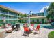 Charming courtyard featuring a shuffleboard court, outdoor seating and tropical landscaping at 801 83Rd N Ave # 412, St Petersburg, FL 33702