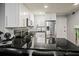 Modern kitchen with black countertops, stainless appliances, and white cabinetry at 801 83Rd N Ave # 412, St Petersburg, FL 33702