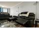 A cozy living room with comfortable recliner seating and a modern coffee table on a striped rug at 801 83Rd N Ave # 412, St Petersburg, FL 33702
