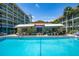 A refreshing community pool with lounge chairs, tables, and a covered area, perfect for relaxation at 801 83Rd N Ave # 412, St Petersburg, FL 33702