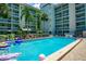 A refreshing community pool with lounge chairs, tables, and a covered area, perfect for relaxation at 801 83Rd N Ave # 412, St Petersburg, FL 33702