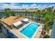 A refreshing community pool with lounge chairs, tables, and a covered area, perfect for relaxation at 801 83Rd N Ave # 412, St Petersburg, FL 33702