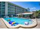 A refreshing community pool with lounge chairs, tables, and a covered area, perfect for relaxation at 801 83Rd N Ave # 412, St Petersburg, FL 33702
