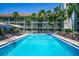 A refreshing community pool with lounge chairs, tables, and a covered area, perfect for relaxation at 801 83Rd N Ave # 412, St Petersburg, FL 33702