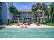 A shuffleboard court surrounded by lush landscaping, seating, and shade, great for community fun at 801 83Rd N Ave # 412, St Petersburg, FL 33702