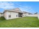 Spacious backyard with healthy green grass, great privacy fence, and an exterior view of the home at 8104 Abbey Mist Cv, Tampa, FL 33619
