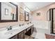 Spacious bathroom featuring double sinks, a tub, and a shower at 8104 Abbey Mist Cv, Tampa, FL 33619