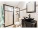 Modern bathroom with a sleek vanity, glass enclosed shower, and stylish fixtures at 8104 Abbey Mist Cv, Tampa, FL 33619