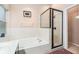 Bright bathroom featuring a tub, shower, and white tile at 8104 Abbey Mist Cv, Tampa, FL 33619