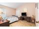 Cozy bedroom with a bed, a desk, and a closet, creating a comfortable living space at 8104 Abbey Mist Cv, Tampa, FL 33619