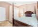 This bedroom features a four poster bed, closet space, and comfortable interior design at 8104 Abbey Mist Cv, Tampa, FL 33619