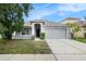 Charming single-story home with a two-car garage, covered entry, and manicured landscaping at 8104 Abbey Mist Cv, Tampa, FL 33619
