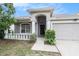 Inviting front entrance with classic columns, manicured shrubbery, and an attached two-car garage at 8104 Abbey Mist Cv, Tampa, FL 33619
