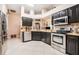 Modern kitchen with stainless steel appliances, sleek cabinets, and granite countertops at 8104 Abbey Mist Cv, Tampa, FL 33619