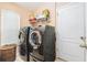 Modern laundry room featuring a side-by-side washer and dryer and built in shelving at 8104 Abbey Mist Cv, Tampa, FL 33619