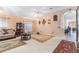 Spacious living room featuring tile flooring, decorative rugs, and elegant furnishings with natural light at 8104 Abbey Mist Cv, Tampa, FL 33619