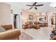 Comfortable living room with tile floors, a ceiling fan, and neutral decor at 8104 Abbey Mist Cv, Tampa, FL 33619
