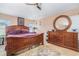 Bedroom featuring a ceiling fan, tile floors, and a large dresser at 8104 Abbey Mist Cv, Tampa, FL 33619