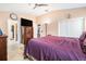Bedroom featuring tile floors, a ceiling fan, and a large dresser at 8104 Abbey Mist Cv, Tampa, FL 33619