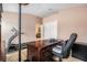 The home office is equipped with a desk, office chair, and a treadmill at 8104 Abbey Mist Cv, Tampa, FL 33619