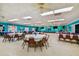 Large, inviting community hall with tables, chairs, and stage setup at 9548 141St St, Seminole, FL 33776