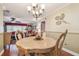 Charming dining area with elegant chandelier and seamless transition to the living room at 9548 141St St, Seminole, FL 33776