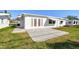 Inviting home exterior with a well-maintained concrete patio and manicured lawn at 9548 141St St, Seminole, FL 33776