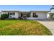 Charming single-story home featuring a well-manicured lawn and inviting curb appeal at 9548 141St St, Seminole, FL 33776