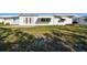 Beautifully maintained front yard with lush green grass and an inviting home facade at 9548 141St St, Seminole, FL 33776
