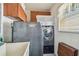 Functional laundry room with a washer, dryer, storage cabinets, and sink at 9548 141St St, Seminole, FL 33776