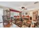 Elegant living room with hardwood floors, ceiling fan, and stylish floral area rug at 9548 141St St, Seminole, FL 33776