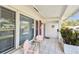 Inviting front porch features tiled flooring, comfortable seating and ample natural light at 9548 141St St, Seminole, FL 33776