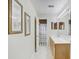 Bathroom with vanity, framed mirror, and shower/bath combo with curtain and framed prints on wall at 10437 River Bream Dr, Riverview, FL 33569