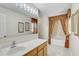 Bathroom vanity with solid-surface counter, drop-in sink and framed prints on wall at 10437 River Bream Dr, Riverview, FL 33569
