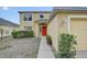 Home exterior featuring meticulously trimmed shrubs, complemented by a bright red front door at 10437 River Bream Dr, Riverview, FL 33569