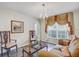 Cozy living room with vinyl floors, comfortable seating, and ornate window treatments for added charm at 10437 River Bream Dr, Riverview, FL 33569