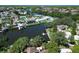 A waterfront home with a private dock, a pool, and mature trees along the waterway at 10729 Drummond Rd, Tampa, FL 33615