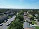 An aerial view of a neighborhood, including houses, apartments, parking lots, and mature trees at 10729 Drummond Rd, Tampa, FL 33615