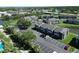 Aerial view of apartments with a pool, parking, mature landscaping, and access to the river at 10729 Drummond Rd, Tampa, FL 33615