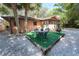 Backyard featuring table, chairs, and tropical landscaping at 10729 Drummond Rd, Tampa, FL 33615