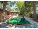 Backyard area featuring table, chairs, and tropical landscaping at 10729 Drummond Rd, Tampa, FL 33615