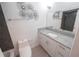 Bathroom with granite countertop, white cabinets, and decorative flower wall art at 10729 Drummond Rd, Tampa, FL 33615