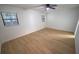 Bright and airy bedroom with two windows and new floors at 10729 Drummond Rd, Tampa, FL 33615