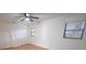 Clean and bright bedroom with new floors, windows, and a ceiling fan at 10729 Drummond Rd, Tampa, FL 33615